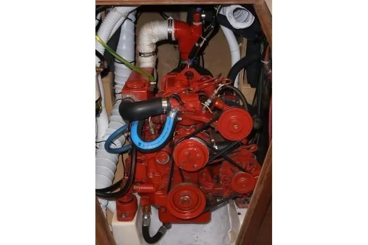 Slide: The Image of Engine compartment of a 1986 Cape Dory 26 sailboat, featuring a red marine engine. - 14