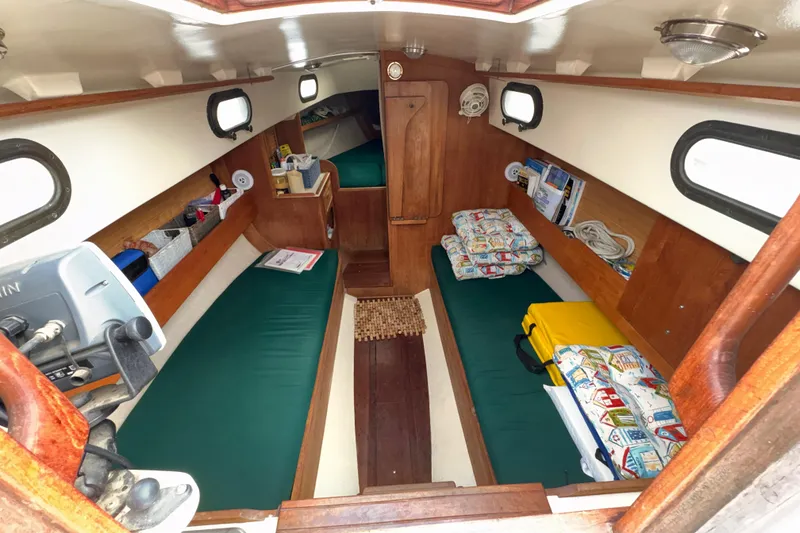 Slide: The Image of Interior of 1986 Cape Dory 26 sailboat with green cushions and wooden accents. - 3
