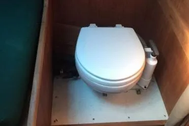 Slide: The Image of 1986 Cape Dory 26 boat toilet in wooden compartment. - 9