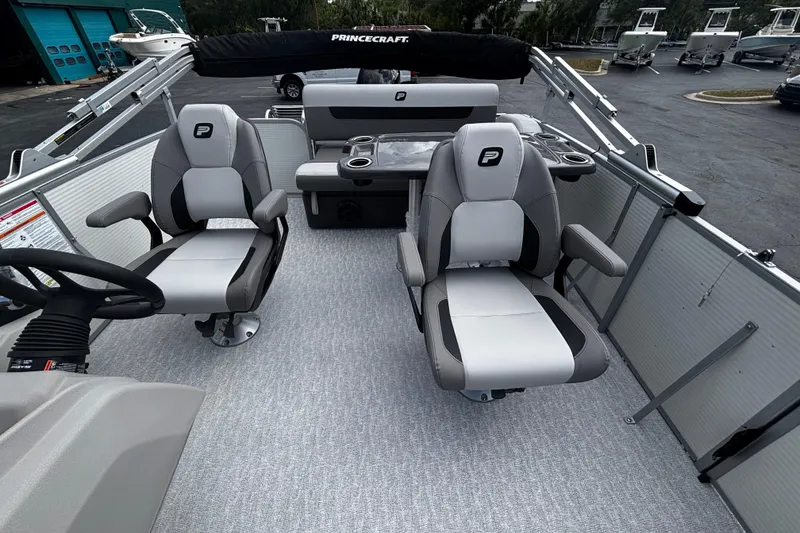 Slide: The Image of 2026 Princecraft Vectra 21 RL pontoon boat interior with modern seating and steering console. - 11