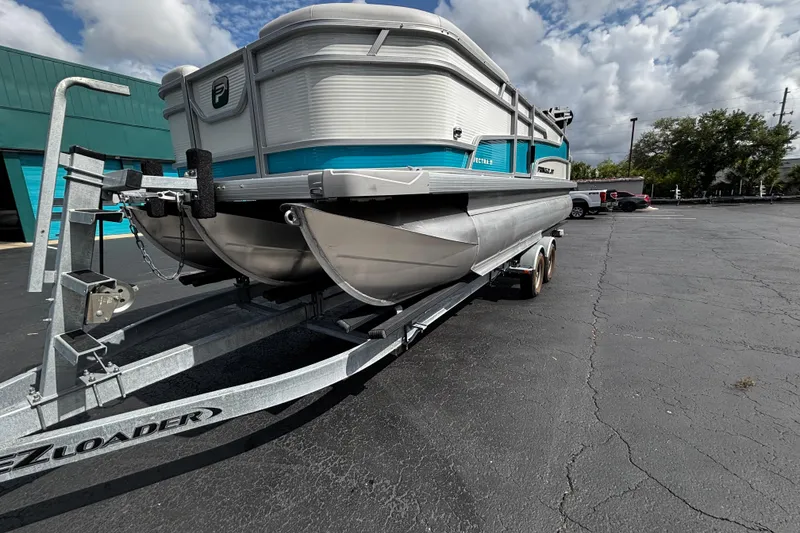 Slide: The Image of 2026 Princecraft Vectra 21 RL pontoon boat on trailer, parked outdoors under cloudy sky. - 3