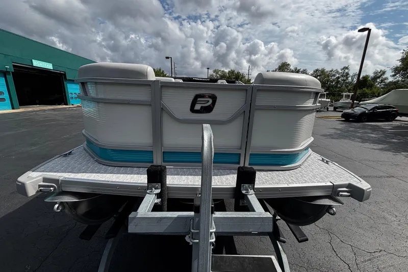 Slide: The Image of 2026 Princecraft Vectra 21 RL pontoon boat on trailer, parked outdoors under cloudy sky. - 4