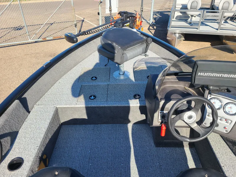 Slide: The Image of 2023 Tracker Pro Guide V16 SC boat interior with steering console. - 16