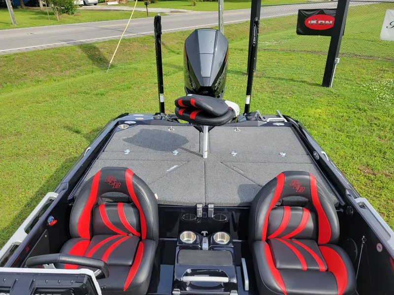 Slide: The Image of Interior of a 2025 Bass Cat Jaguar boat with red seats. - 14