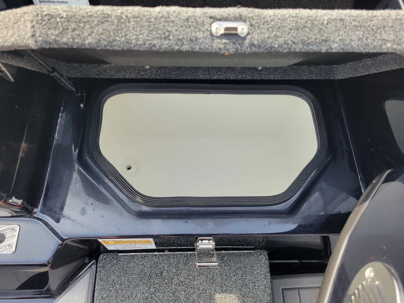 Slide: The Image of 2025 Bass Cat Jaguar boat storage compartment with carpeted interior. - 20