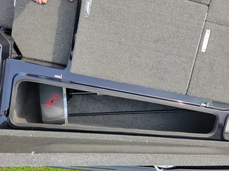 Slide: The Image of 2025 Bass Cat Jaguar boat with storage compartment and carpeted floor. - 22