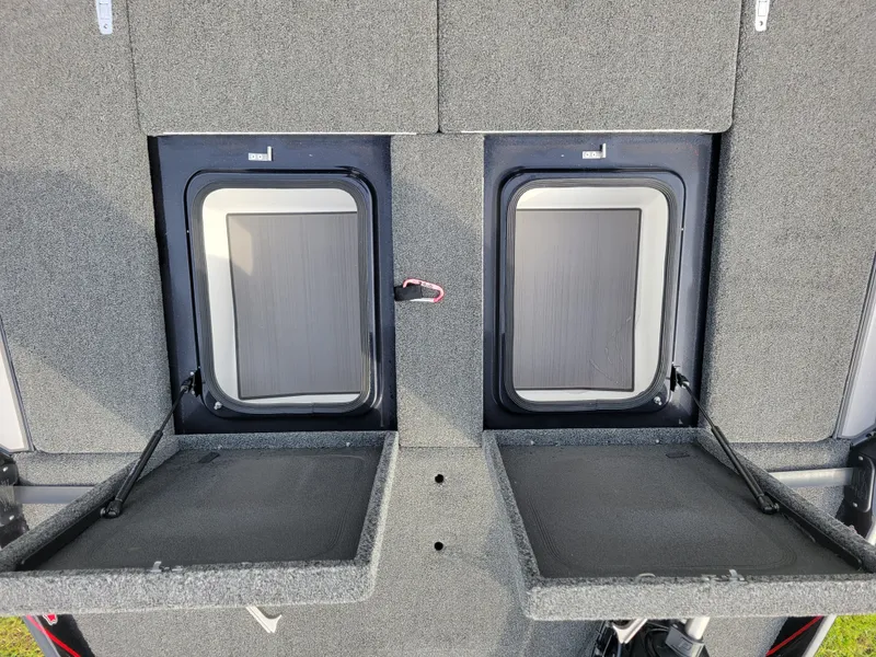 Slide: The Image of Bass Cat Jaguar 2025 storage compartments with open hatches. - 23