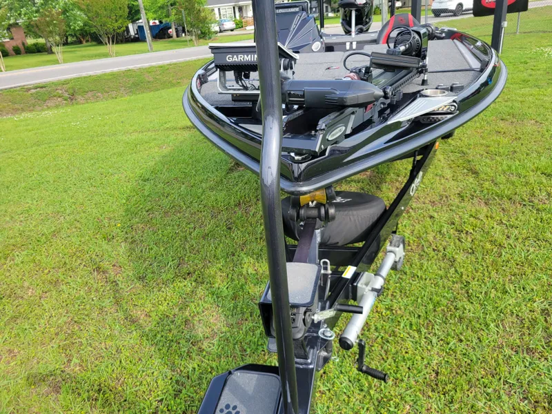 Slide: The Image of 2025 Bass Cat Jaguar boat parked on green grass. - 36