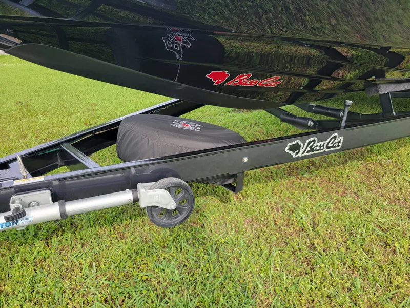 Slide: The Image of Bass Cat Jaguar 2025 on trailer, close-up on grass. - 37