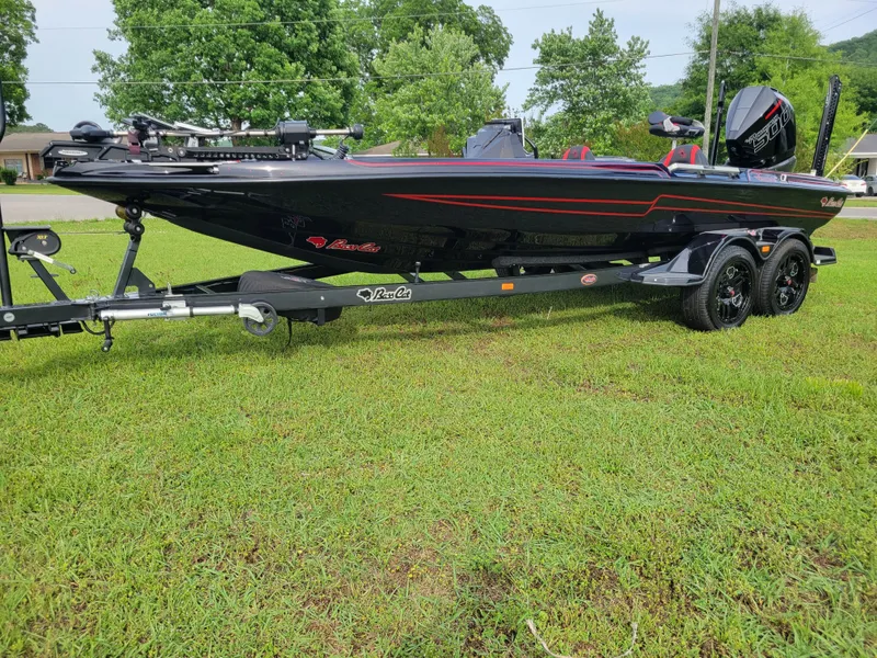 Slide: The Image of 2025 Bass Cat Jaguar boat on trailer outdoors. - 41