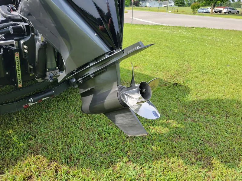 Slide: The Image of 2025 Bass Cat Jaguar boat motor on green grass. - 6