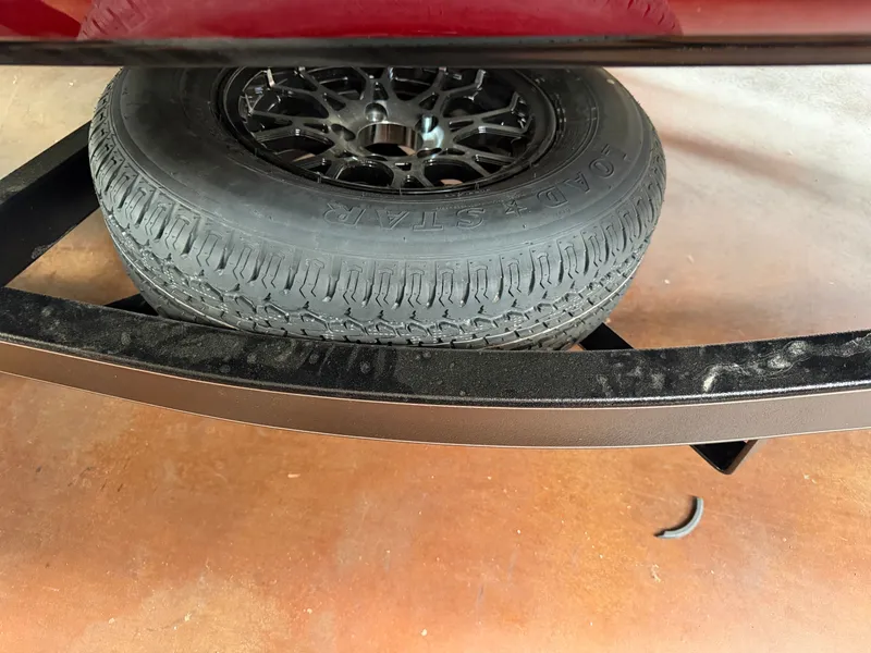Slide: The Image of Spare tire of 2026 Falcon F195 on a metal frame. - 24