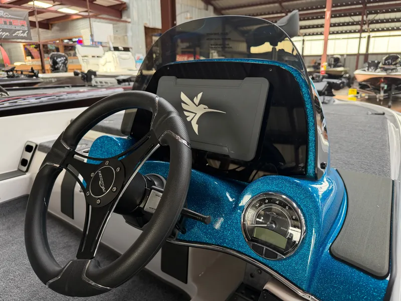 Slide: The Image of Falcon F195 boat dashboard with steering wheel and tachometer, year 2026. - 16