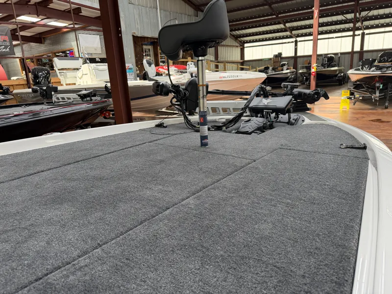Slide: The Image of Falcon F195 2026 boat with gray carpeted deck in showroom. - 6