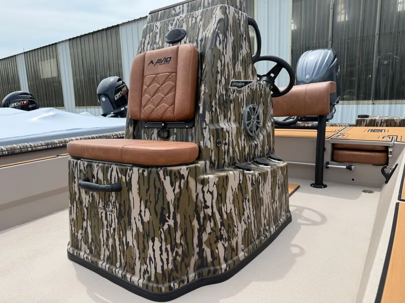 Slide: The Image of 2026 Avid 20CC Rogue boat with camouflage design and leather seats. - 12