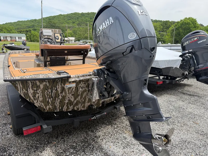 Slide: The Image of Avid 20CC Rogue 2026 boat with Yamaha 150 engine, parked outdoors. - 4