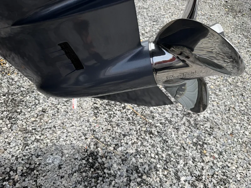 Slide: The Image of Avid 20CC Rogue 2026 boat motor with shiny propeller on gravel. - 5