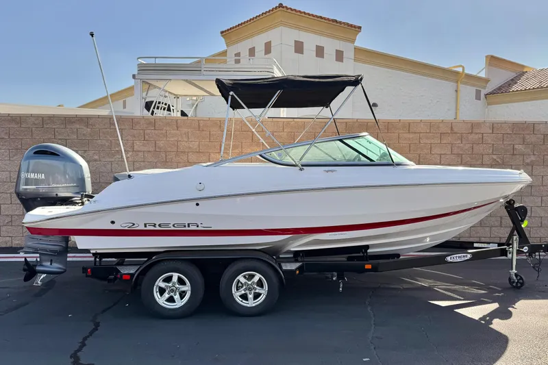 The Image of 2019 Regal 21 OBX boat with Yamaha engine on trailer, parked outdoors. - 0