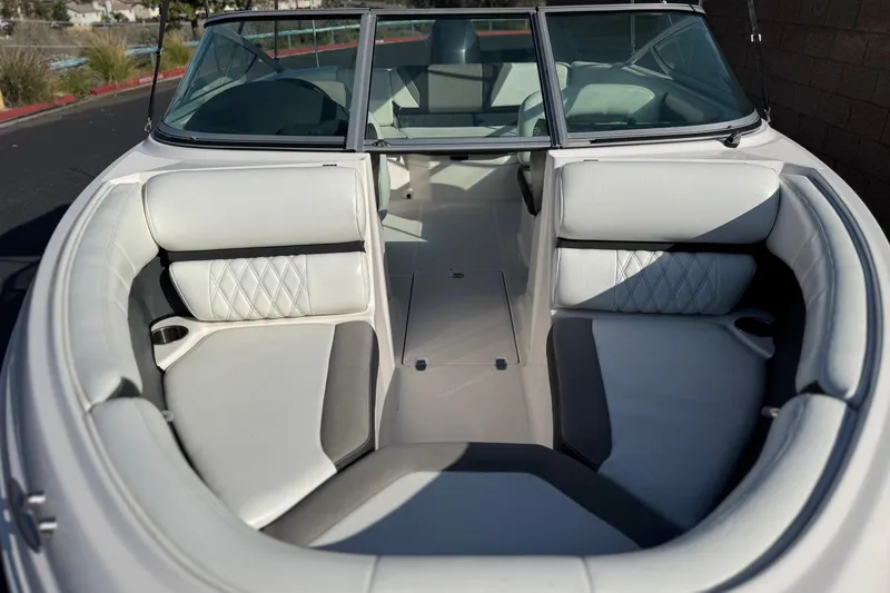 Slide: The Image of 2019 Regal 21 OBX boat interior with white cushioned seating and windshield. - 10