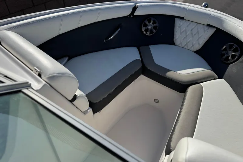 Slide: The Image of Interior seating of a 2019 Regal 21 OBX boat, featuring cushioned seats and speakers. - 12