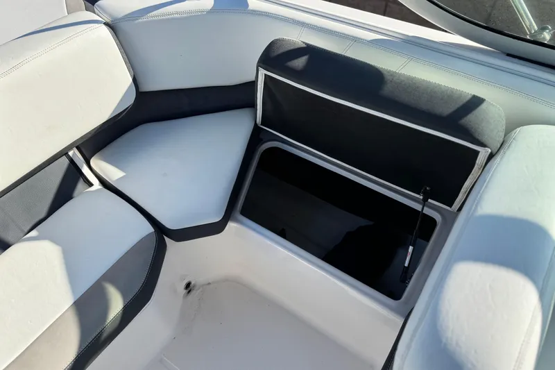 Slide: The Image of 2019 Regal 21 OBX boat interior with open storage compartment and cushioned seating. - 19