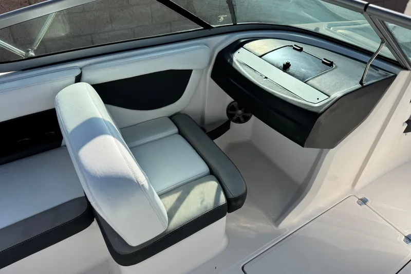 Slide: The Image of Interior of a 2019 Regal 21 OBX boat featuring white seating and dashboard. - 20