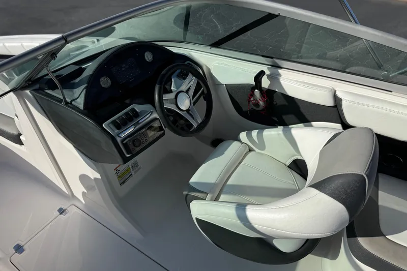 Slide: The Image of Interior view of a 2019 Regal 21 OBX boat cockpit with steering wheel and seating. - 23