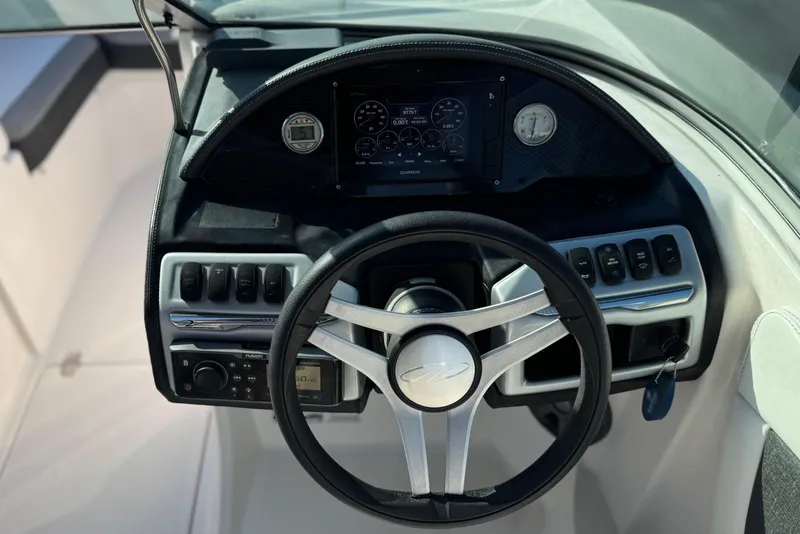 Slide: The Image of Steering console of a 2019 Regal 21 OBX boat with modern controls and dashboard. - 24