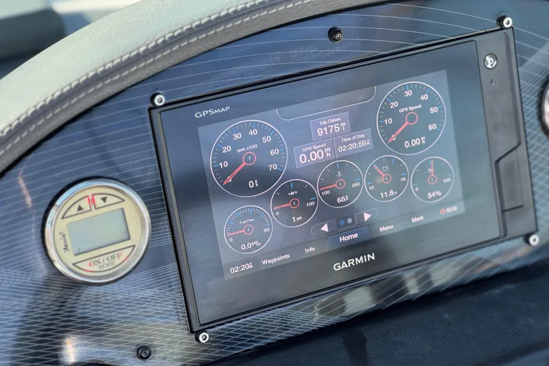 Slide: The Image of Dashboard of a 2019 Regal 21 OBX boat featuring a Garmin GPS display. - 26