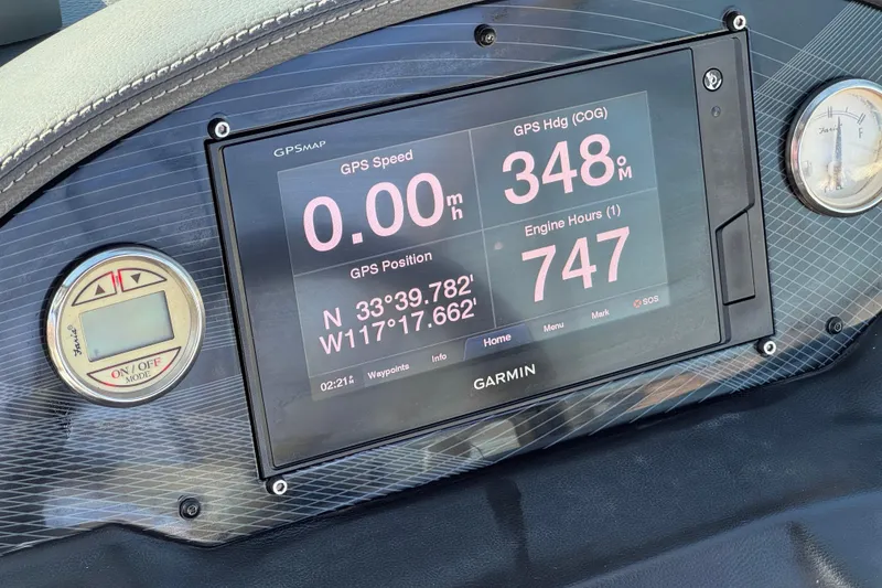 Slide: The Image of Garmin GPS display on 2019 Regal 21 OBX boat dashboard, showing speed, heading, and engine hours. - 29