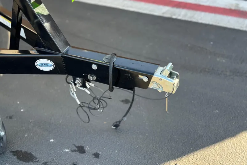 Slide: The Image of Trailer hitch of a 2019 Regal 21 OBX boat on asphalt surface. - 31