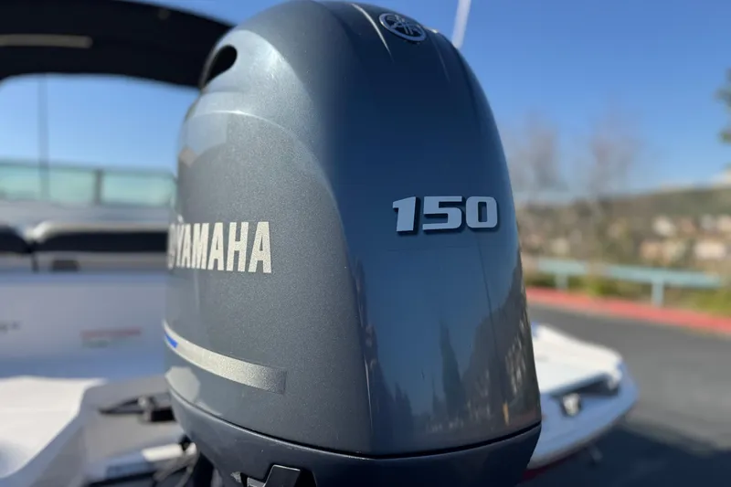 Slide: The Image of Yamaha 150 outboard motor on 2019 Regal 21 OBX boat, sunny day background. - 7