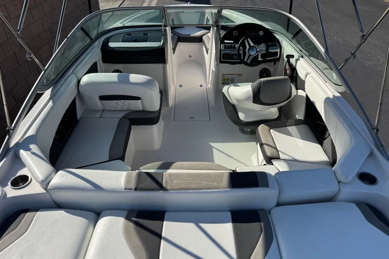 Slide: The Image of 2019 Regal 21 OBX boat interior with modern seating and steering wheel. - 8