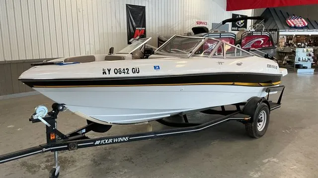 The Image of 2002 Four Winns 180 Horizon boat on trailer in warehouse. - 1