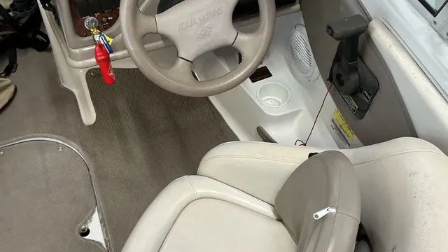 Slide: The Image of Interior of a 2002 Four Winns 180 Horizon boat with steering wheel. - 11