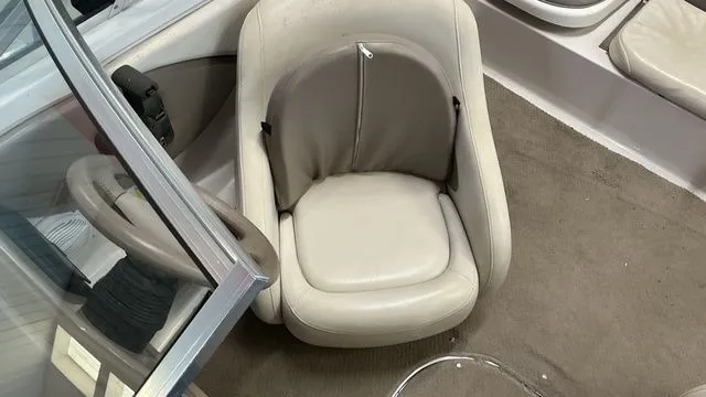 Slide: The Image of Interior of a 2002 Four Winns 180 Horizon boat with beige seating. - 14
