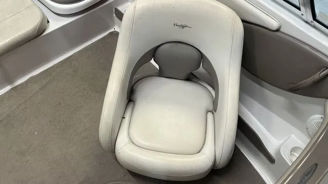 Slide: The Image of Interior of a 2002 Four Winns 180 Horizon boat with beige seating. - 15