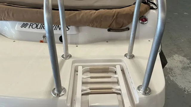 Slide: The Image of Rear view of a 2002 Four Winns 180 Horizon boat with swim ladder. - 16