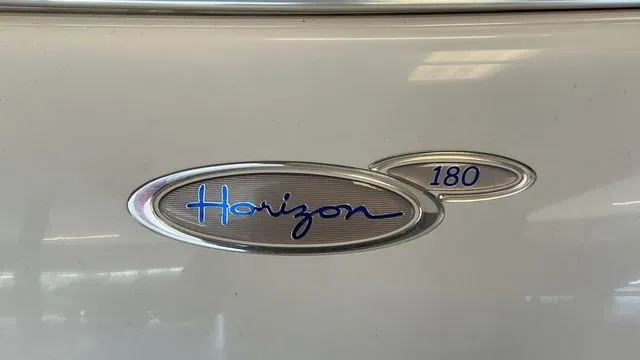 Slide: The Image of 2002 Four Winns 180 Horizon boat emblem. - 17
