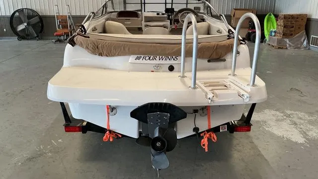 Slide: The Image of Rear view of a 2002 Four Winns 180 Horizon boat in a garage. - 3