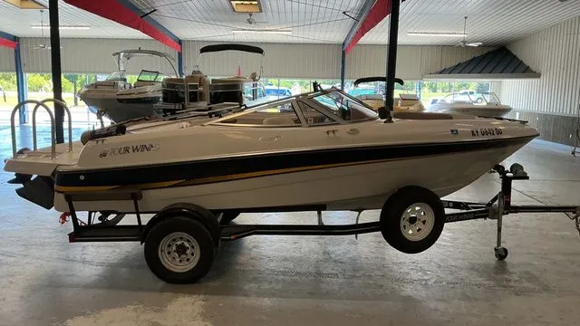 Slide: The Image of 2002 Four Winns 180 Horizon boat on trailer in warehouse. - 6