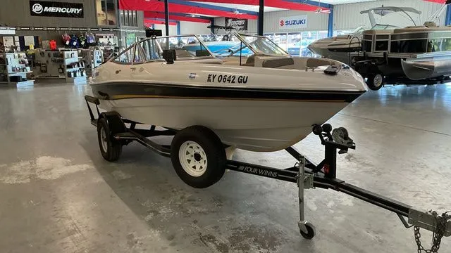 Slide: The Image of 2002 Four Winns 180 Horizon boat on trailer in showroom. - 7