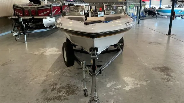 Slide: The Image of 2002 Four Winns 180 Horizon boat in a showroom. - 8