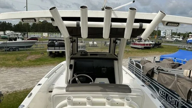 Slide: The Image of 2022 World Cat 235 CC boat with fishing rod holders and helm station. - 4