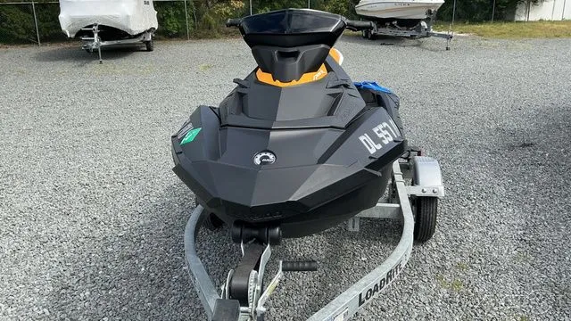 The Image of 2021 Sea-Doo SPARK 3I jet ski on trailer, gray gravel lot. - 1