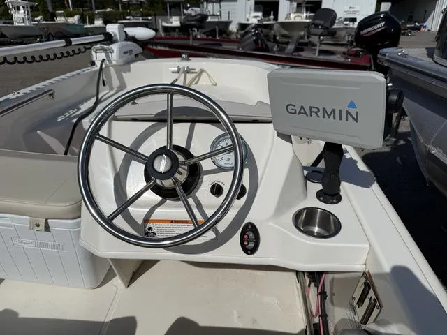 Slide: The Image of Steering console of a 2023 Boston Whaler 130 Super Sport boat. - 12