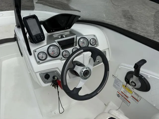 Slide: The Image of Dashboard of a 2018 Tahoe 550 TS boat with steering and instruments. - 11