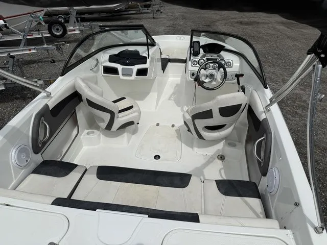 Slide: The Image of Interior of a 2018 Tahoe 550 TS boat with steering wheel and seats. - 13