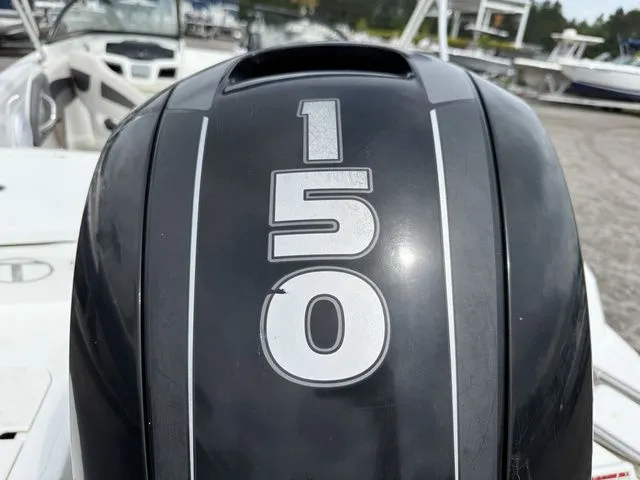 Slide: The Image of Close-up of a 150 HP outboard motor on a Tahoe 550 TS boat. - 16
