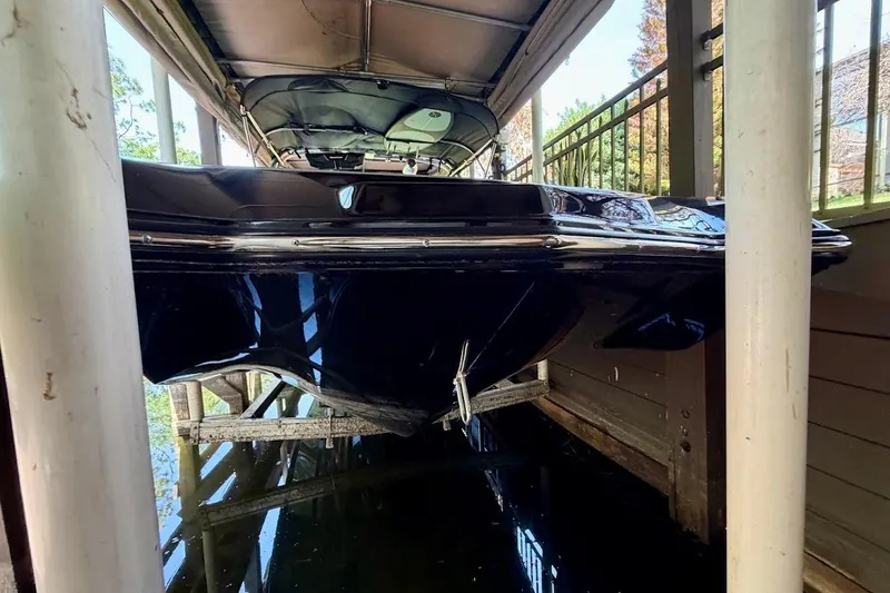 Slide: The Image of 2023 MasterCraft NXT20 boat docked in covered slip, side view. - 13